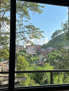a view of a city from a window at Hotel Aagaman - Best Family Hotel in Bandipur in Bandipur