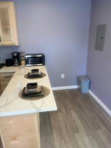 a kitchen counter with a toaster and glasses on it at A beautiful guest house/ Downey in Downey