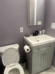 a bathroom with a white toilet and a sink at A beautiful guest house/ Downey in Downey