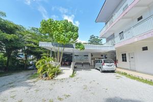 a car parked in front of a building at OYO 90879 Eleven Inn in Kuah