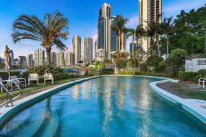 a swimming pool with a city skyline in the background at Amazing Water Views Surfers Paradise in Gold Coast