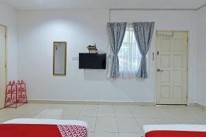 a white room with a door and a window at OYO 90879 Eleven Inn in Kuah