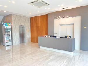 an empty lobby with a counter and a refrigerator at JIA HAUS Hotel Apartment in Buriram