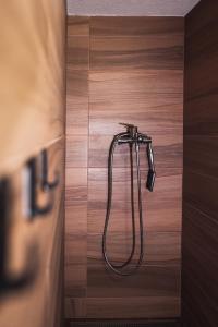 a shower in a bathroom with a wooden floor at maringotka schovanka in Malá Morávka