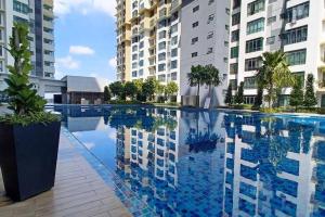 a large swimming pool in front of some buildings at Homestay ARC Cozyhome Austin Hills 4-5pax in Johor Bahru
