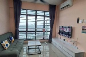 a living room with a couch and a large window at Homestay ARC Cozyhome Austin Hills 4-5pax in Johor Bahru