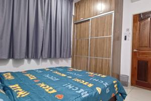 a bedroom with a bed and a wooden cabinet at Homestay ARC Cozyhome Austin Hills 4-5pax in Johor Bahru +31 photos