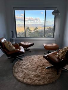 a waiting room with chairs and a large window at The View @ Ulandi in Lowther