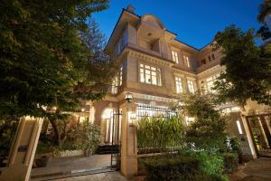a large house with a gate in front of it at Luxury Garden Villa with premium spa 4 bedrooms Ciputra in Hanoi