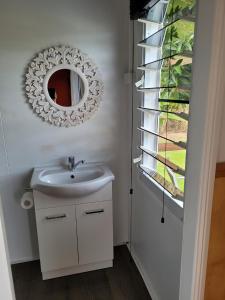 a bathroom with a sink and a mirror at Carmila Caravan Park & Cabins in Carmila