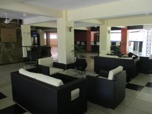 a living room with couches and a table at Indiana Beach Apartments in Bamburi