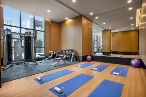a gym with a bunch of yoga mats in a room at Wanda Jin Pingxiang in Pingxiang