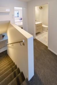 a staircase leading to a bathroom and a bedroom at Heart of Christchurch CBD Hideaway 2bed 1 bath in Christchurch