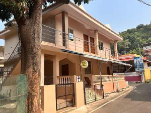 a house with a tree in front of it at James Guesthouse in Bogmolo
