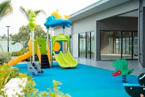 a playground with a slide in a house at Căn hộ 53m đủ nội thất 1PN 1WC bếp free hồ bơi, GYM, BBQ tại Warterpoint Bến Lức in Bến Lức