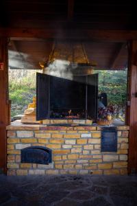 a stone oven with smoke coming out of it at Glamping Pod Gwiazdami in Pietrusza Wola