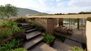 a garden with stairs and plants in front of a building at Lujo Hotel Bodrum in Guvercinlik