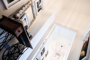 a hallway with a staircase and a door with pictures on the wall at AB OvO in Cagliari