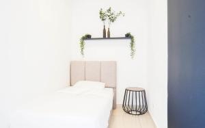 a white room with a white couch and a table at Boulevard Service Apartment KL by Airhost in Kuala Lumpur +32 photos