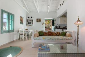 a living room with a couch with stuffed animals on it at Sira Stonehouse l in Volímai