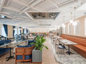 a dining room with long tables and chairs at Kremlin Palace in Lara