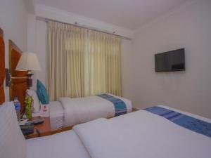 Ein Bett oder Betten in einem Zimmer der Unterkunft Hotel Bodhiz TUSAL