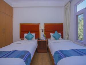 Ein Bett oder Betten in einem Zimmer der Unterkunft Hotel Bodhiz TUSAL
