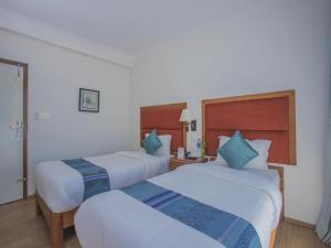 Ein Bett oder Betten in einem Zimmer der Unterkunft Hotel Bodhiz TUSAL