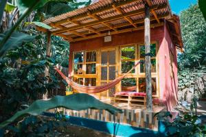 a hammock in front of a tree house at Banana Farm Eco Hostel in Arusha