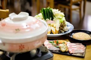 a counter top with food and a pot on a stove at Hiyoshi Forest Resort Yamanoie in Nantan city