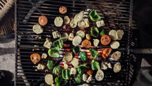 a bunch of food being grilled on a grill at Kanatal Kutir in Kanatal