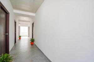 an empty hallway with potted plants and a ceiling at FabHotel Rooms 27 in Hyderabad