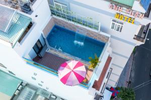an overhead view of a swimming pool with a pink umbrella and a swimming pool at Gold Holiday Hotel in Vung Tau