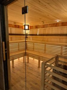a empty sauna with benches and a light in it at Silveroks Hotel in Bukovel