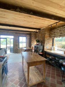 a kitchen with a wooden table in a room at Yellowwoods Farm - WILLOUGHBYS COTTAGE and OLD STABLES COTTAGE in Curryʼs Post