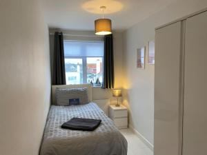 a small bedroom with a bed and a window at Horizon View in South Hayling