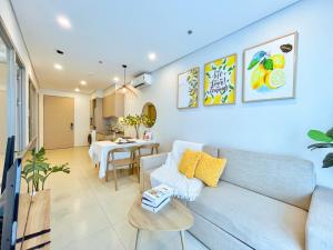 a living room with a couch and a table at The Song Luxury Condotel Vung Tau - Xuân's Homestay in Vung Tau