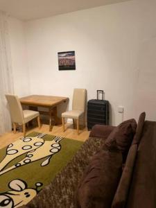 a living room with a couch and a table at Big room for 2 pers, 9 min to trade fare, FREE parking in Frankfurt/Main