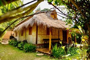 a small hut with a bench in front of it at Rinjani Lighthouse in Senaru
