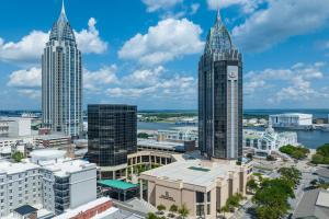 a city with tall buildings and a clock tower at Renaissance Mobile Riverview Plaza Hotel in Mobile