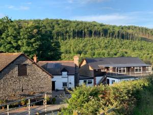 a group of houses with a hill in the background at Cottage with outstanding views in Velindre