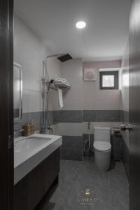 a bathroom with a tub and a sink and a toilet at Lamour homestay in Thôn Kim Long (1) +32 photos