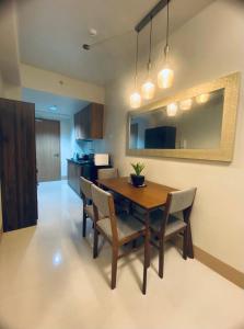 a dining room with a wooden table and chairs at SHORE RESIDENCES 1 BD UNIT FOR RENT in Manila