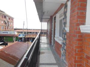 a balcony of a brick building with a window at Psalms Motel in Entebbe