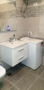 a white bathroom with a sink and a toilet at Holiday apartment Paraiso in Playa Paraiso