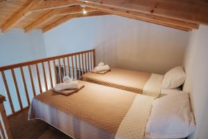a bedroom with two beds in a room at Villa di Vino in Lefkada Town