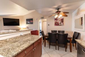 a kitchen and dining room with a table and chairs at Stylish, Cozy 2BR,2BA Condo near Rio, Vegas Luxury in Las Vegas