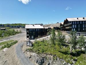 a building on the side of a dirt road at Kikut Alpin Lodge Ski in - Ski out in Geilo