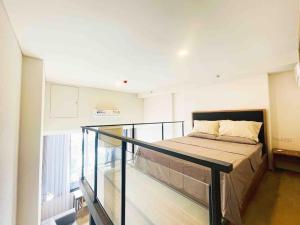 a bedroom with a bed and a glass railing at Ramada素坤逸87 Loft 空中酒吧 高层景观 BTS On Nut in Bangkok