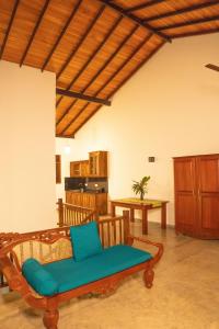 a living room with a couch and a table at New Mangosteen Garden Villa in Hikkaduwa